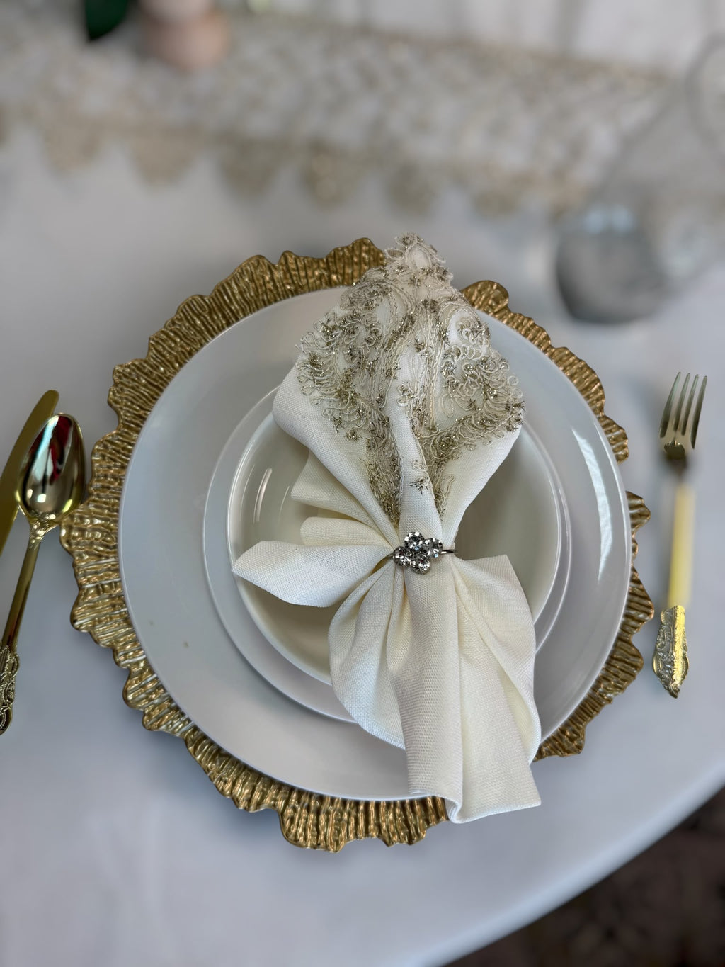 Luxury Turkish linen napkin with elegant gold lace embroidery and decorative napkin ring from the Empire Lumina round tablecloth set.