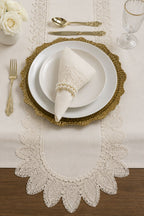 Elegant Empire Lumina place setting featuring an off-white 100% Turkish linen table runner, embroidered napkin with pearl napkin ring, white dinnerware, and gold flatware.