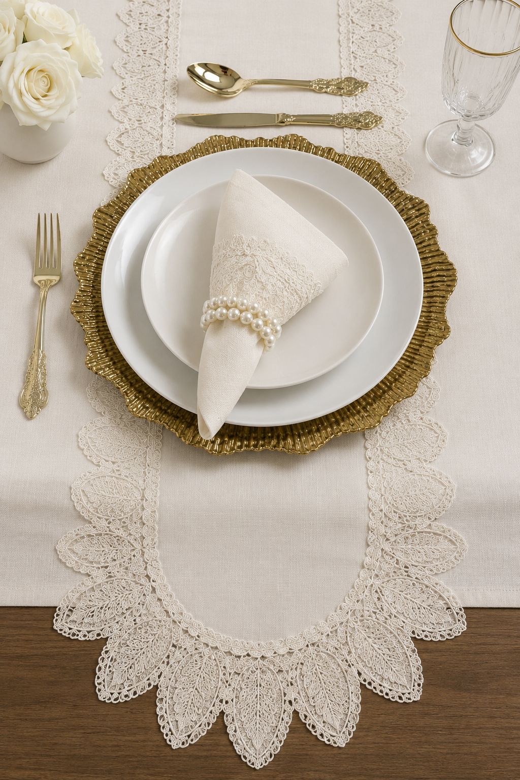 Elegant Empire Lumina place setting featuring an off-white 100% Turkish linen table runner, embroidered napkin with pearl napkin ring, white dinnerware, and gold flatware.