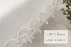 Luxury off-white 100% Turkish linen stain-resistant tablecloth with elegant embroidered lace trim, showcasing the premium fabric texture and protective finish.