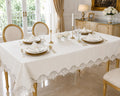 Luxury stain-resistant Turkish linen tablecloth set in off-white, elegantly styled on a gold dining table with white dinnerware in a sophisticated luxury dining room.