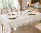 Luxury stain-resistant Turkish linen tablecloth set in off-white, elegantly styled on a gold dining table with white dinnerware in a sophisticated luxury dining room.