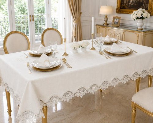 Luxury stain-resistant Turkish linen tablecloth set in off-white, elegantly styled on a gold dining table with white dinnerware in a sophisticated luxury dining room.